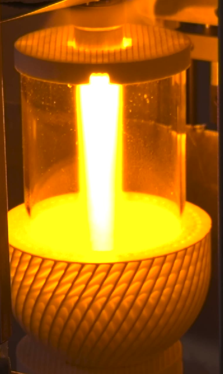 Sodium flame column confined in a quartz tube above a glowing knurled burner, LightCell bench